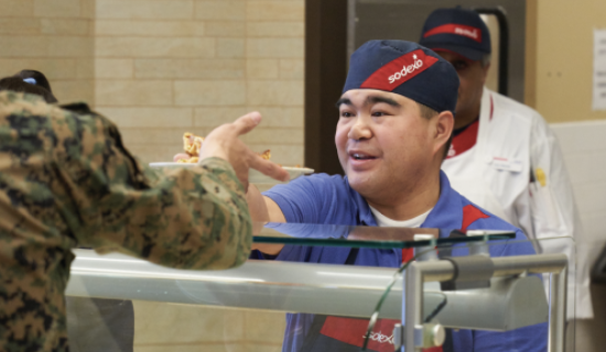Man serving food to a soldier