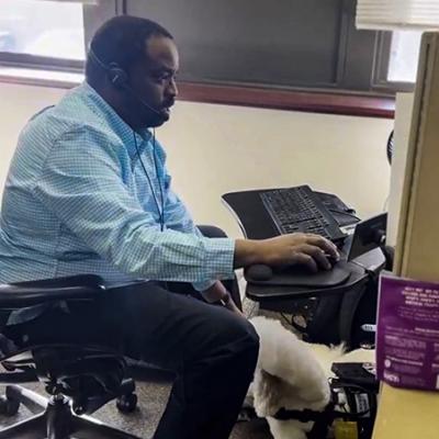 Man sitting at computer who works at Cherokee Federal